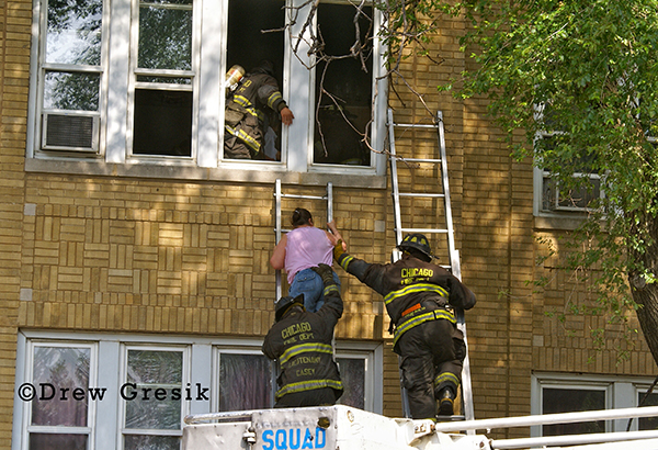 Chicago firemen rescue woman from building on ladder