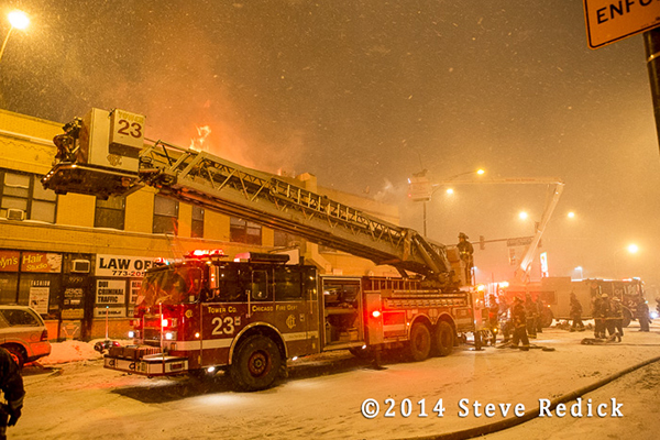 night fire scene in frigid temperatures and blowing snow