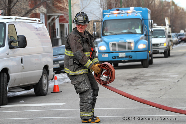 fireman rolling LDH hose