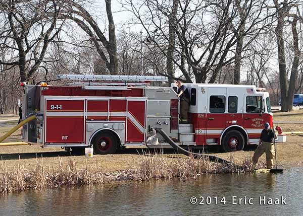 fire engine drafting water from a pond
