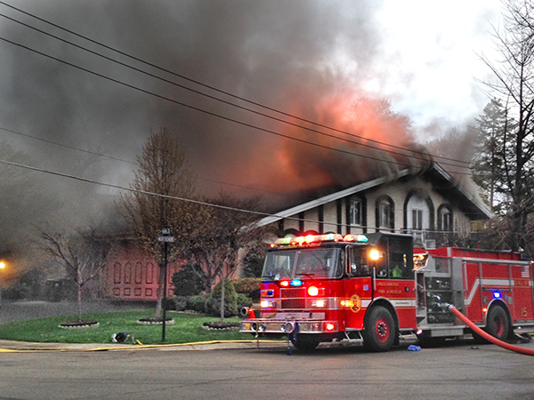 firemen battle a smokey house fire