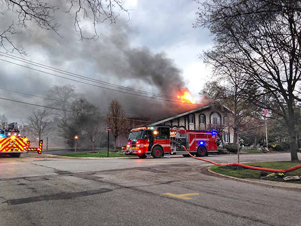 firemen battle a smokey house fire