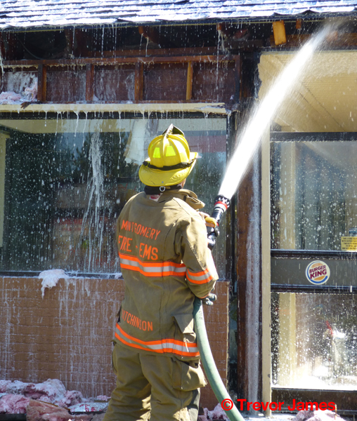 fireman using hose on hot spots