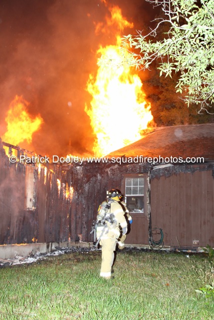 house fully-engulfed in fire at night