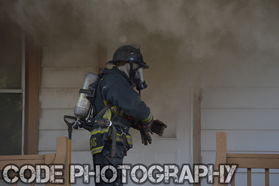 fireman prepares to enter house fire