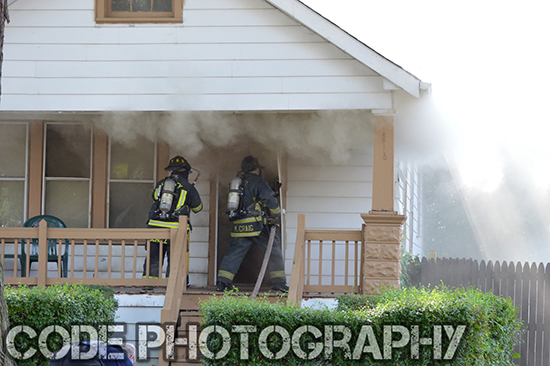 firefighters enter house on fire