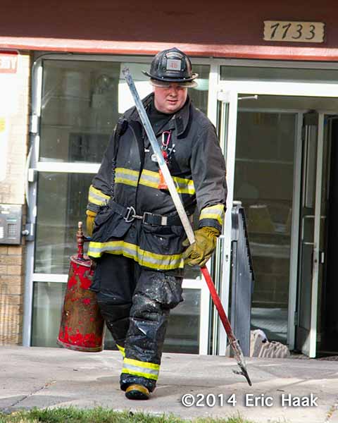 fireman with tools after battling a fire