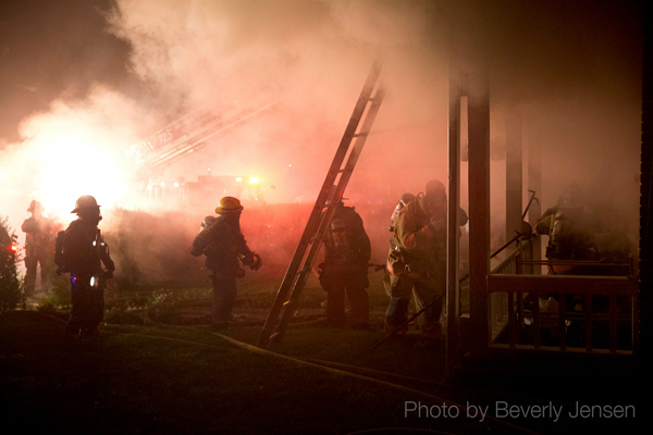 firefighters engulfed in smoke at night fire scene