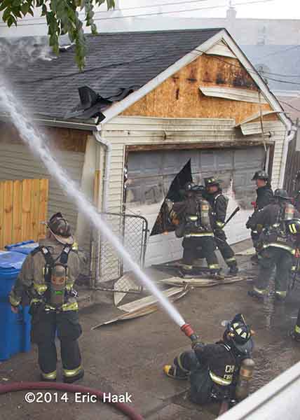 firemen cut into alley garage
