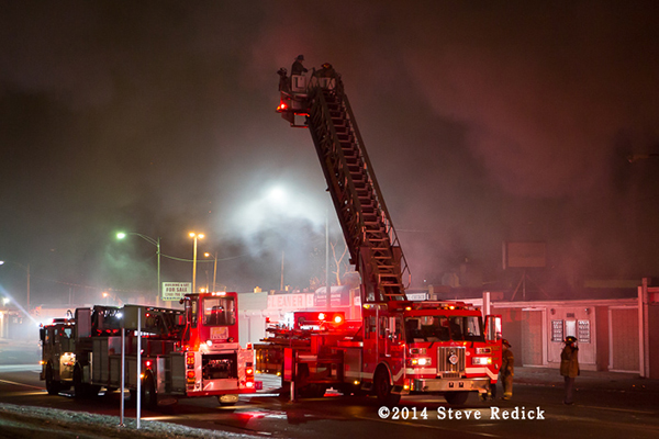 Detroit fire trucks at a commercial building fire at night