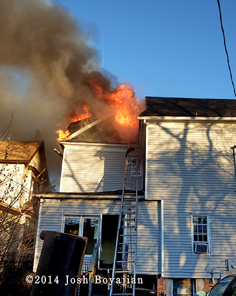 flames through the roof of a house 