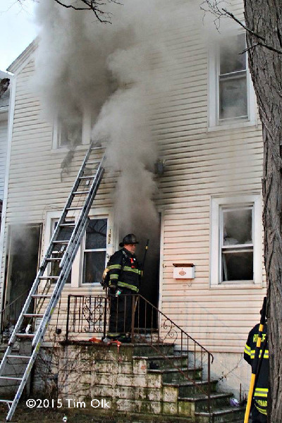 fireman at house fire with smoke