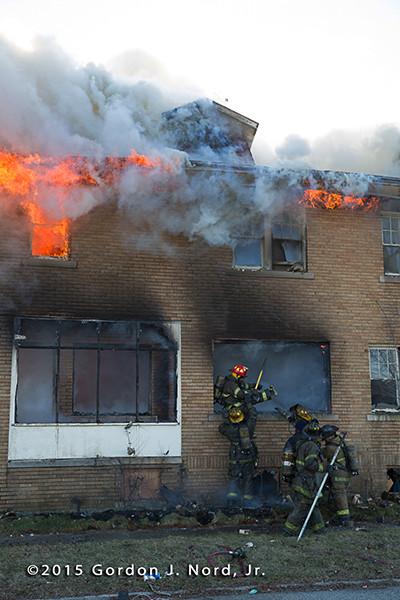 firemen exit vacant burning building