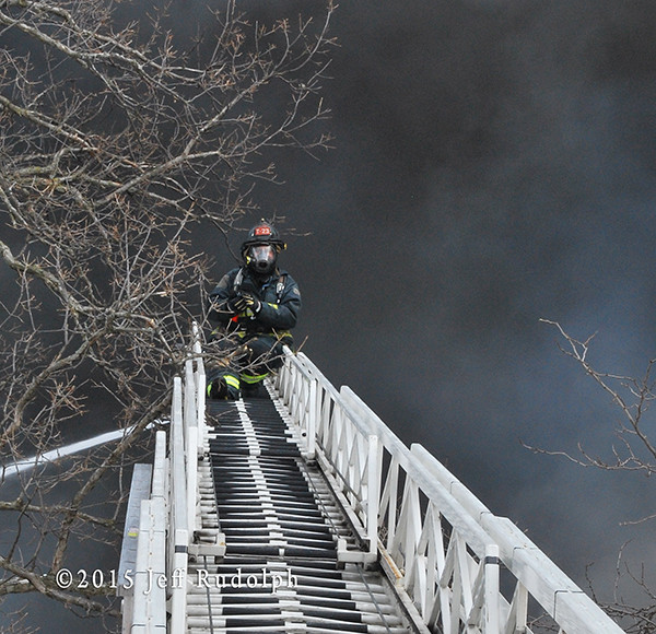 fireman on ladder with black smoke