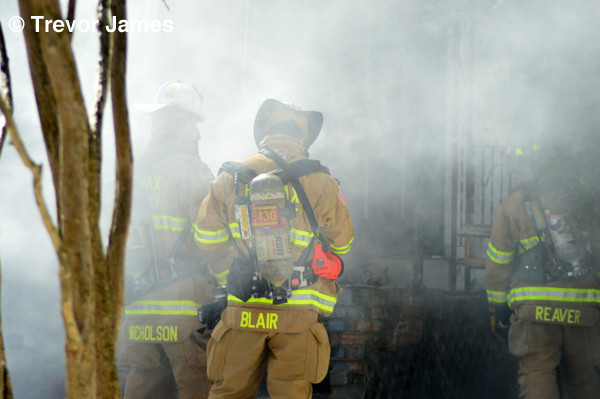 firemen at house fire in smoke