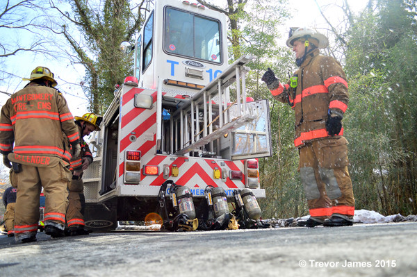 fireman pulls ladder from fire truck