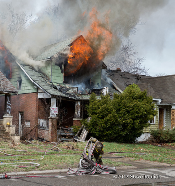 Detroit firemen at the scene of a well involved vacant dwelling fire