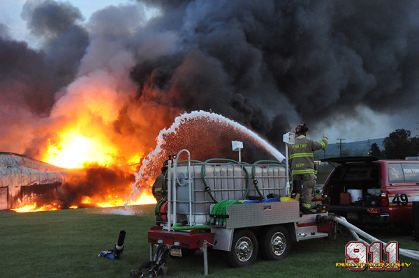 firemen apply foam at chemical fire