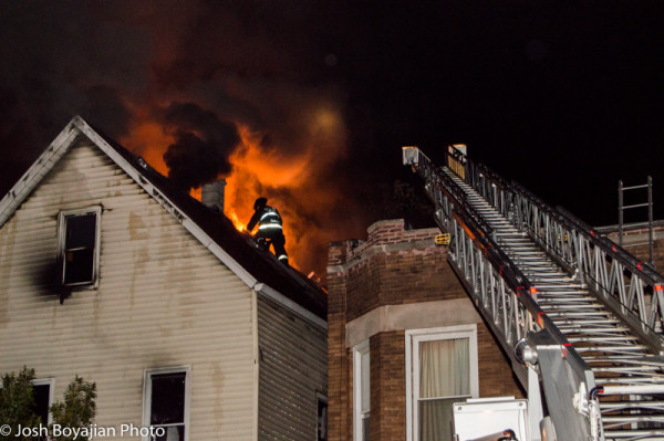 Chicago firemen on roof with heavy fire at night