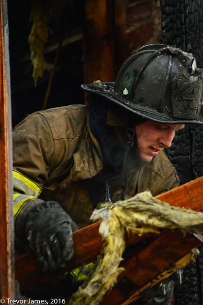 DCFD firefighter overhauls fire scene