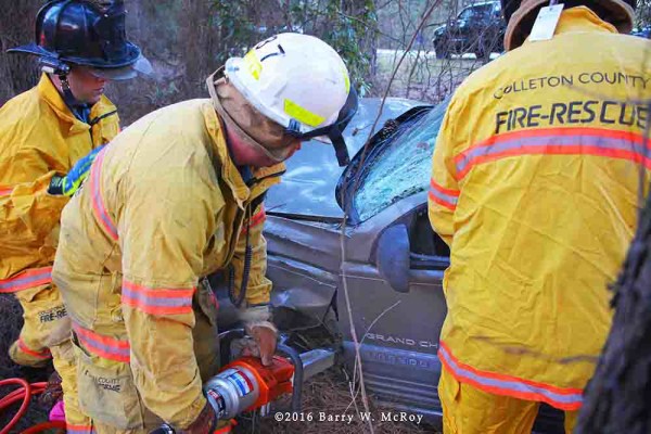 firefighters use Holmatro tools to free crash victim