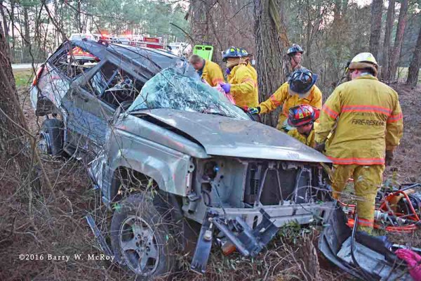 firefighters work to free crash victim from Jeep Cherokee