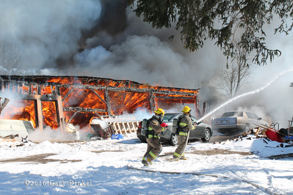 firefighters battle barn fire in the winter