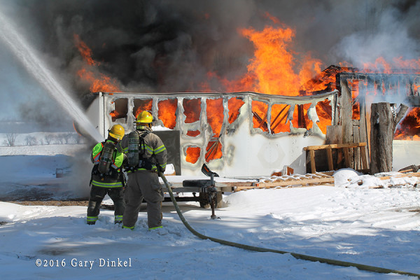 firefighters battle barn fire in the winter