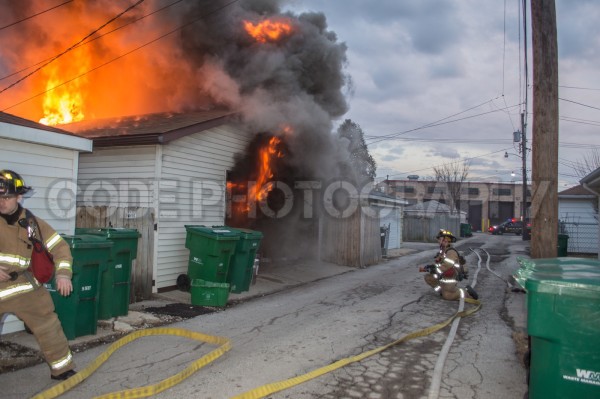 alley garage engulfed in flames