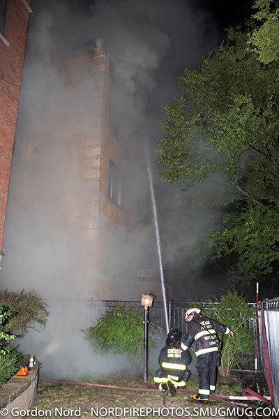 firefighter with hose line at night