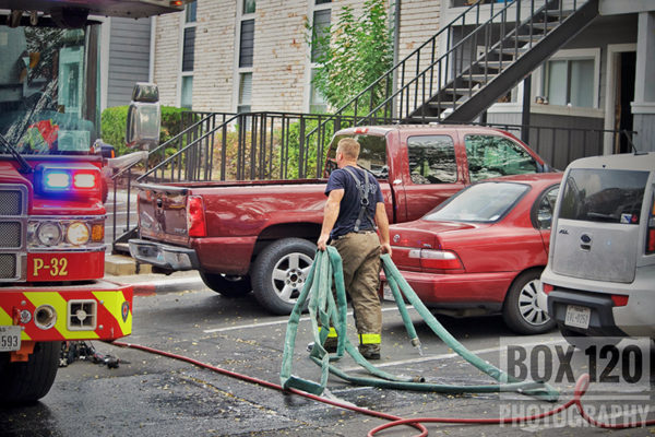 firefighter dragging hose