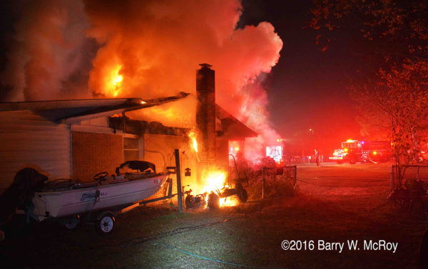 ranch house on fire with flames