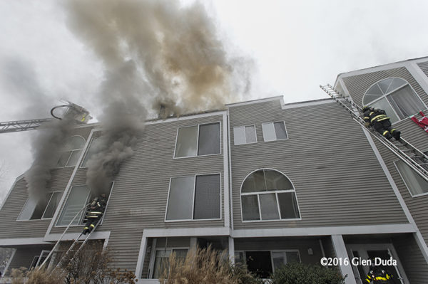 firefighters battle fire in a condo building