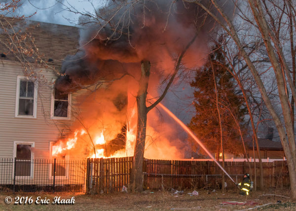 flames engulf the rear of a house