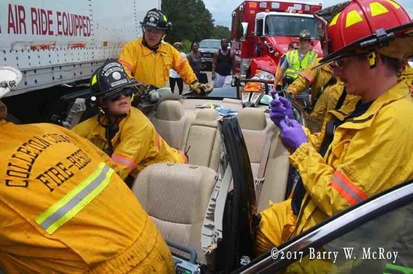 firefighter-paramedics assist crash victim