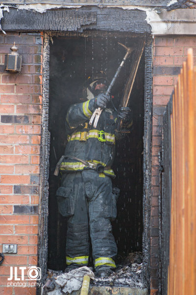 firefighter overhaul after house fire