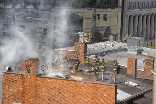 Firefighters vent apartment building roof
