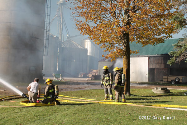 firefighters with deluge gun at barn fire