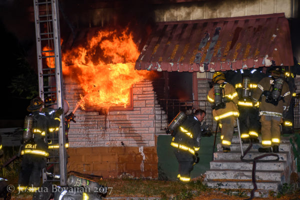 firefighters enter burning house