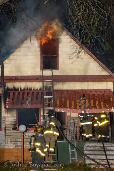 firefighters battle a house fire