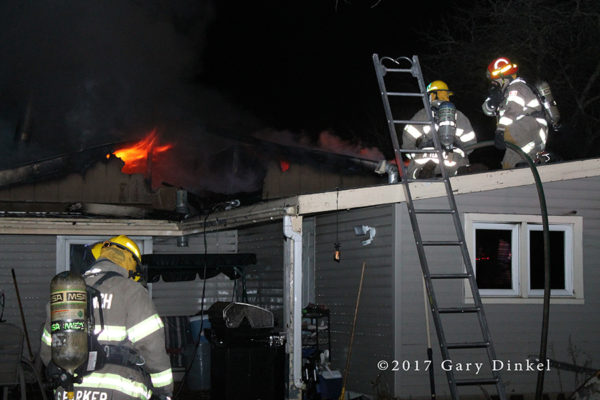 firefighters battle house fire 
