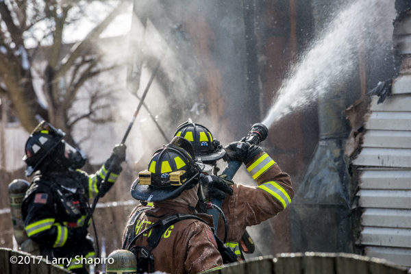 firefighters operate a hose line cathouse fire
