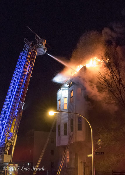 tower ladder battles fire at night