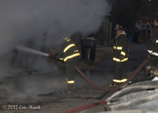 firefighters with hose line and smoke