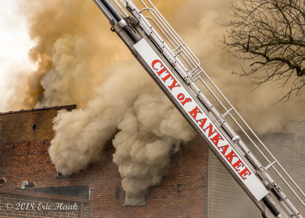 Firefighters battle building fire with heavy smoke
