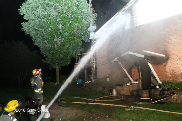 Firefighters in Woolwich Township Ontario battle a house fire at night