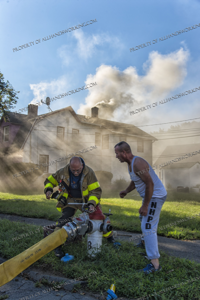 Firefighter opens hydrant during fire