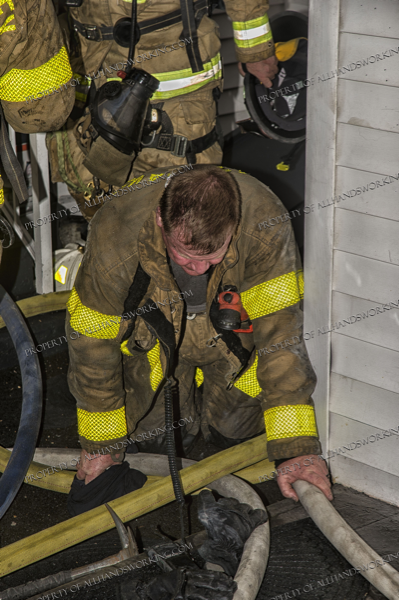 Firefighters crawl from basement after rescuing a victim