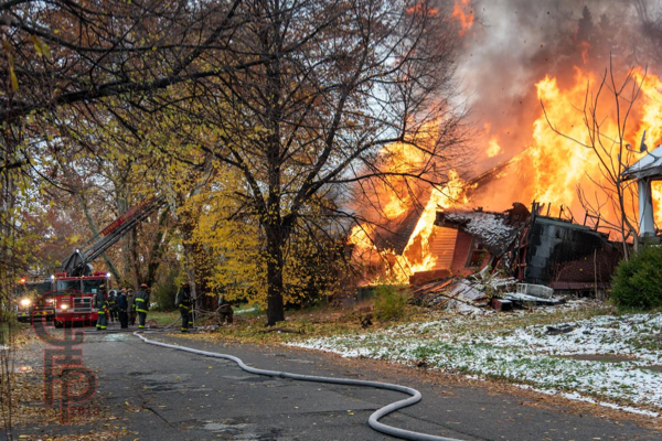Detroit Firefighters monitor a vacant dwelling engulfed by fire