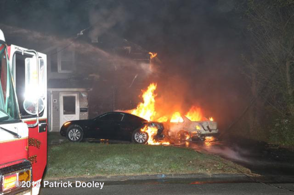 car engulfed in flames spreads to house